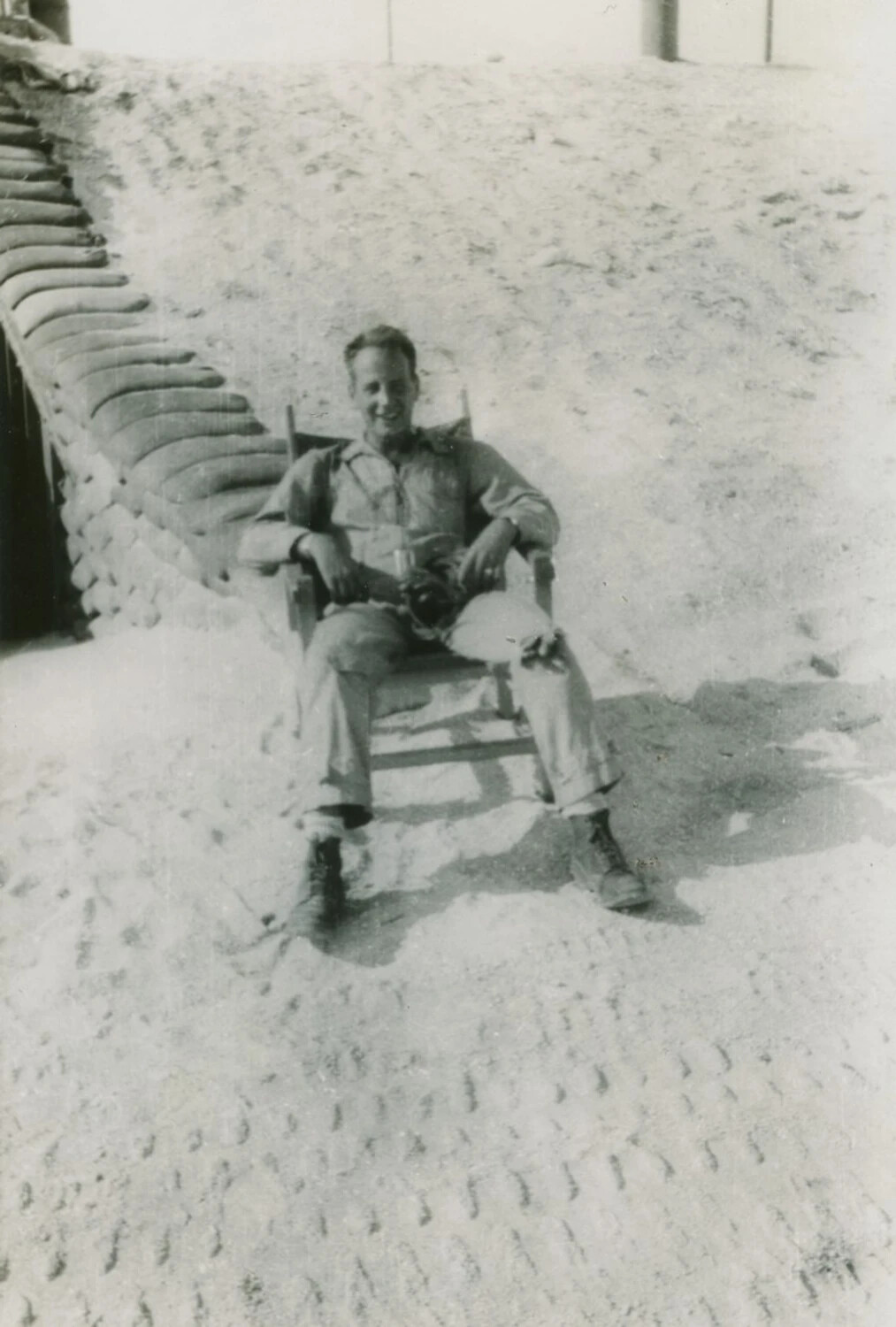 Serviceman Seated Before Sandbag Revetment, Pat McAleer Photo Album