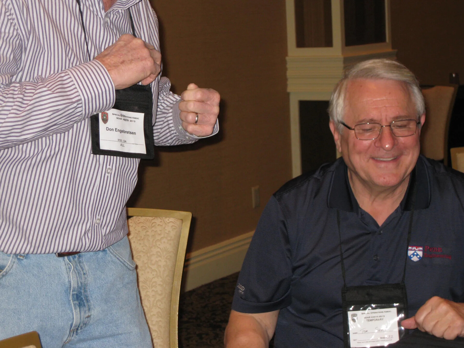 Don Engebretsen Displaying His SOAR XXXVII Credential Beside a Laughing Attendee, Las Vegas, 2013