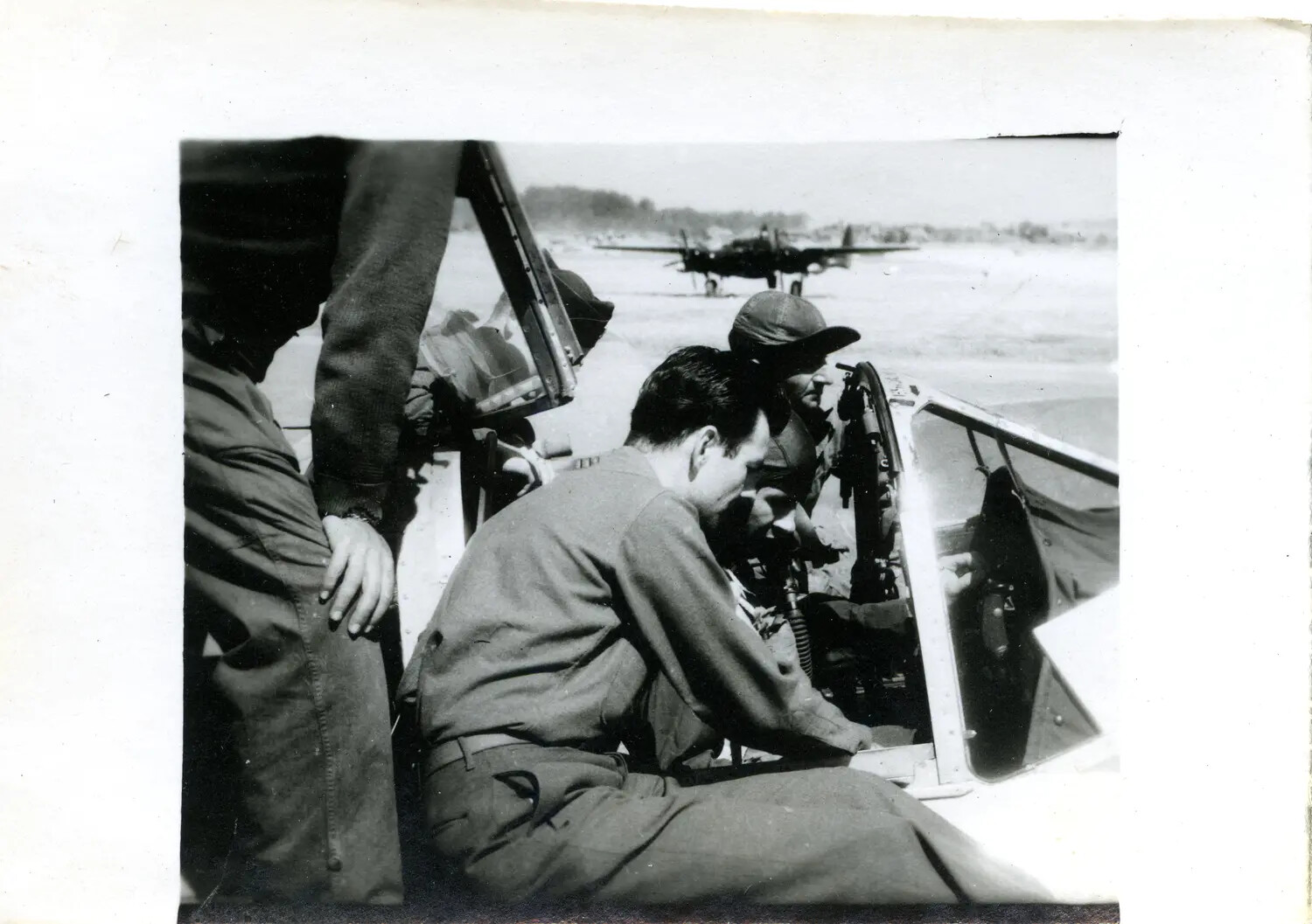 Airmen Examining Fighter Cockpit on Flight Line - CBI Theater Archive