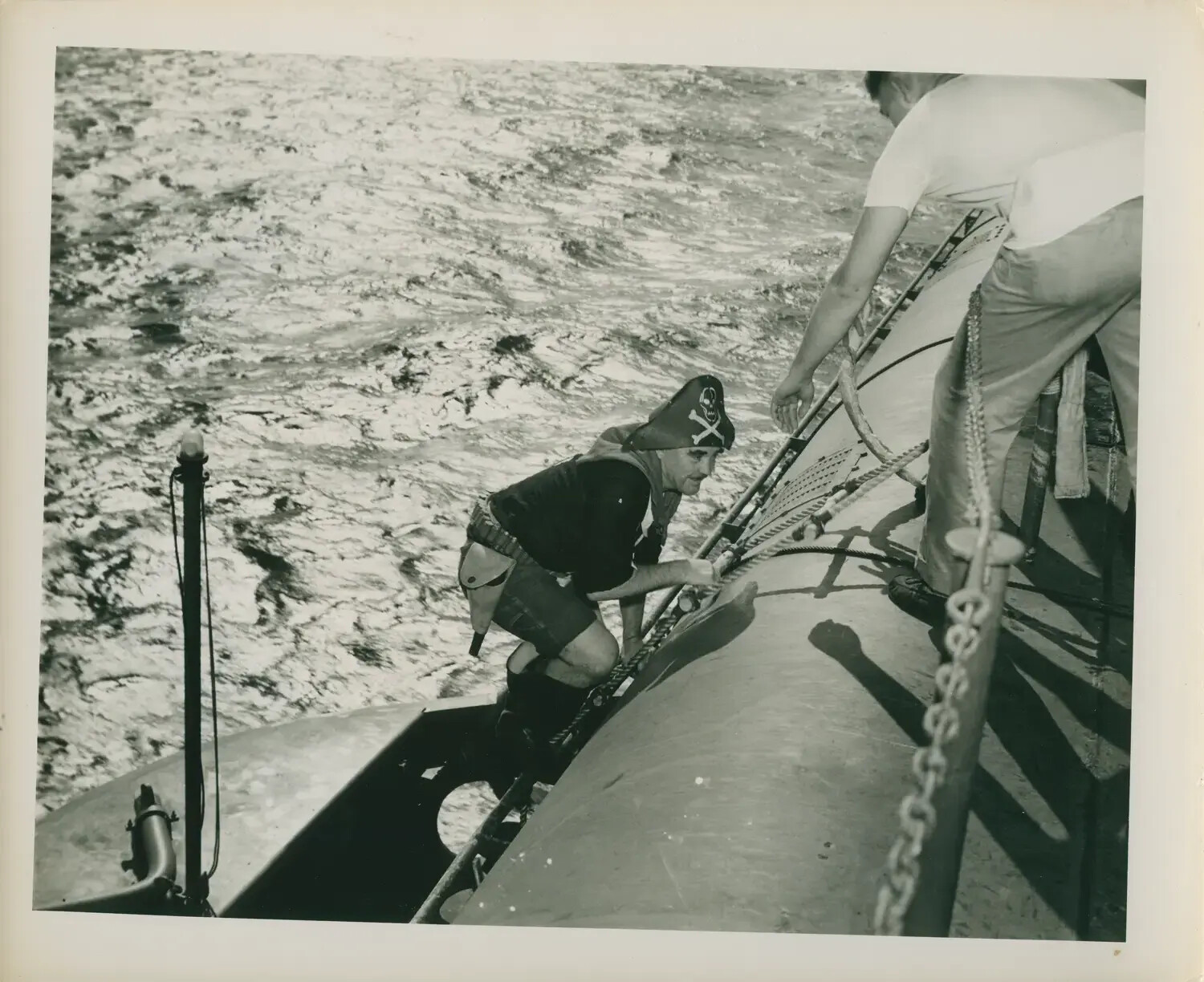 Sailor in Improvised Pirate Costume Boarding Vessel, USS Petrof Bay Collection, WWII