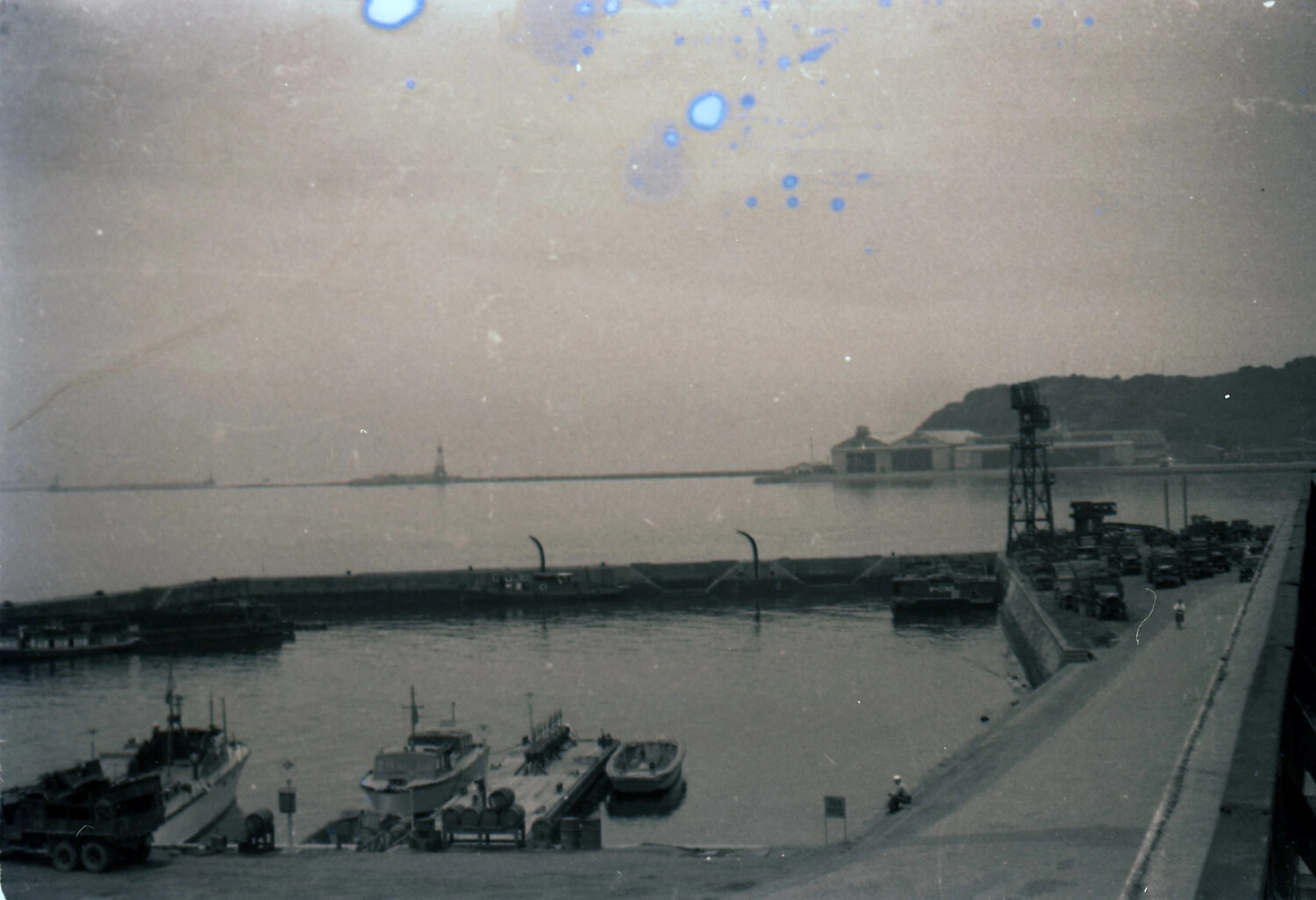 Elevated View of Naval Harbor Facility with Vehicle Convoy, likely Yokosuka, Japan, early 1950s