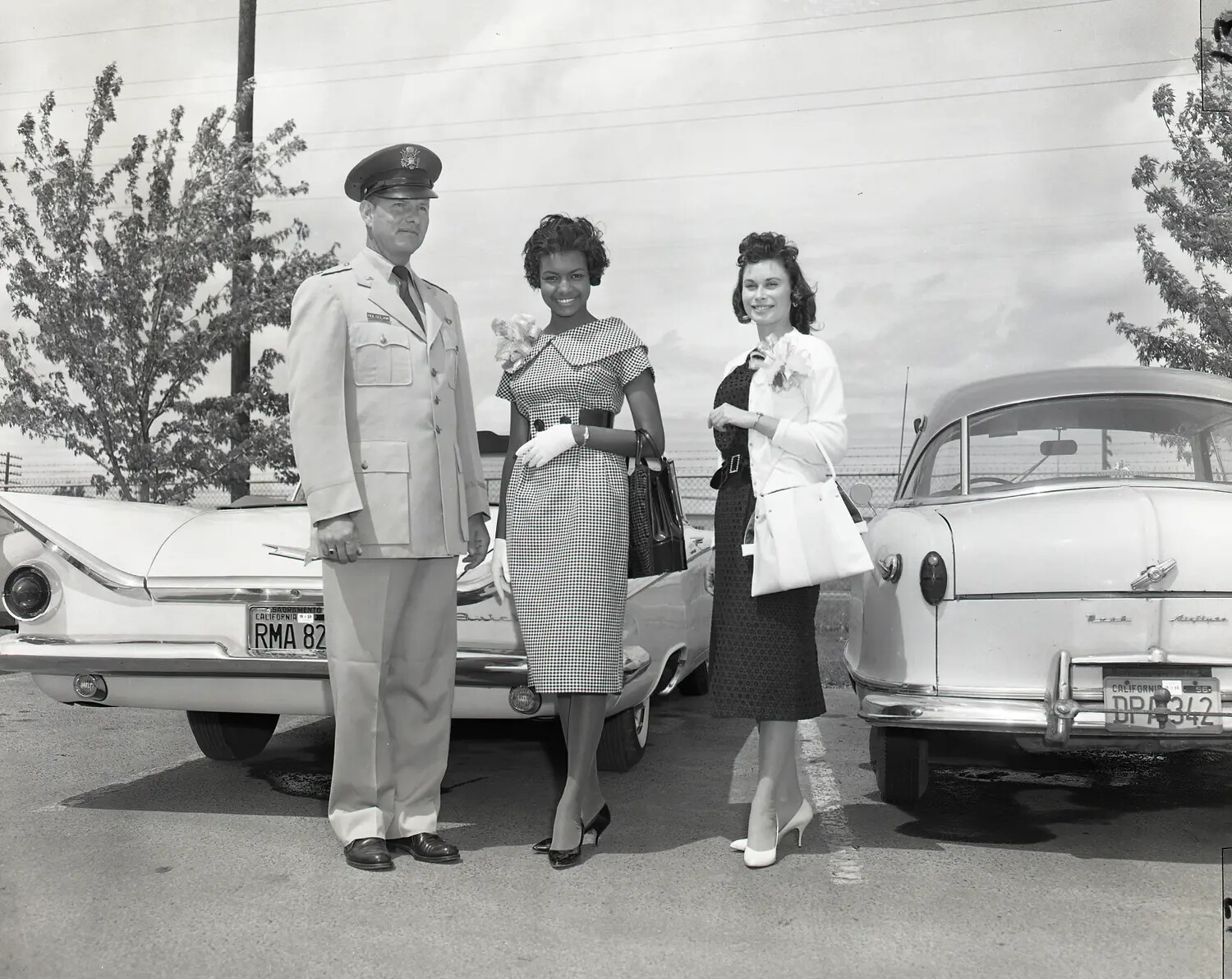 Air National Guard Officer Escorting Two Women at Base Parking Area, Sacramento Area, California