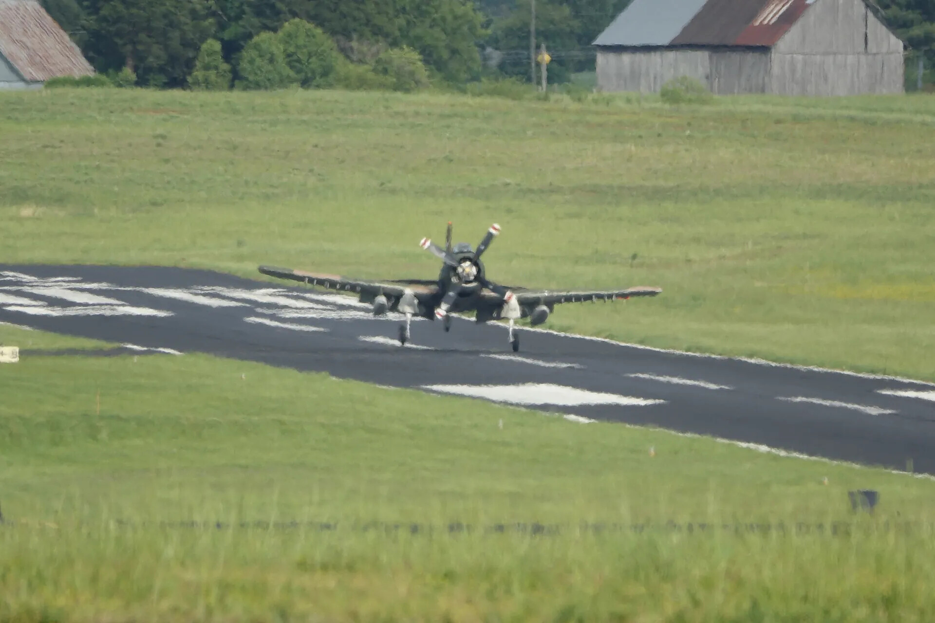 A-1 Skyraider on Runway with Twin Barns in Background, Telephoto View