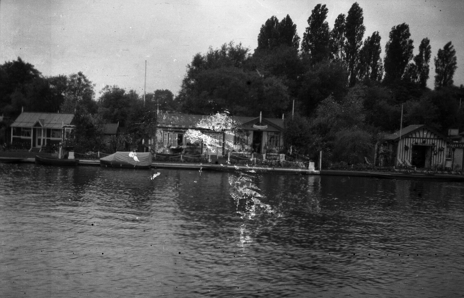 Riverside Boathouses and Poplar Trees, England, WWI Era (Damaged Negative)