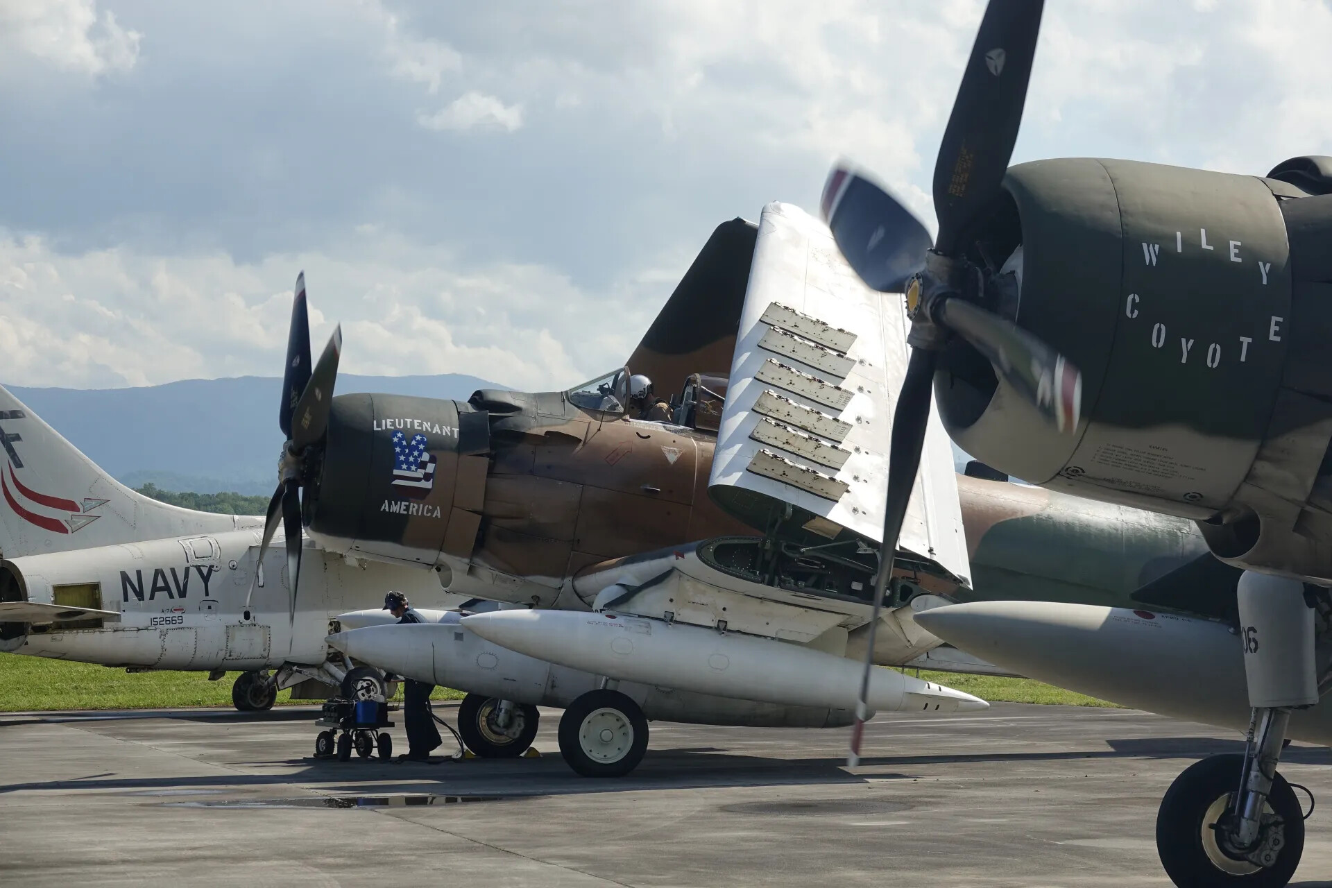 Douglas A-1 Skyraider "Wiley Coyote" and Navy A-7A Corsair II on Ramp, Warbird Airshow Event