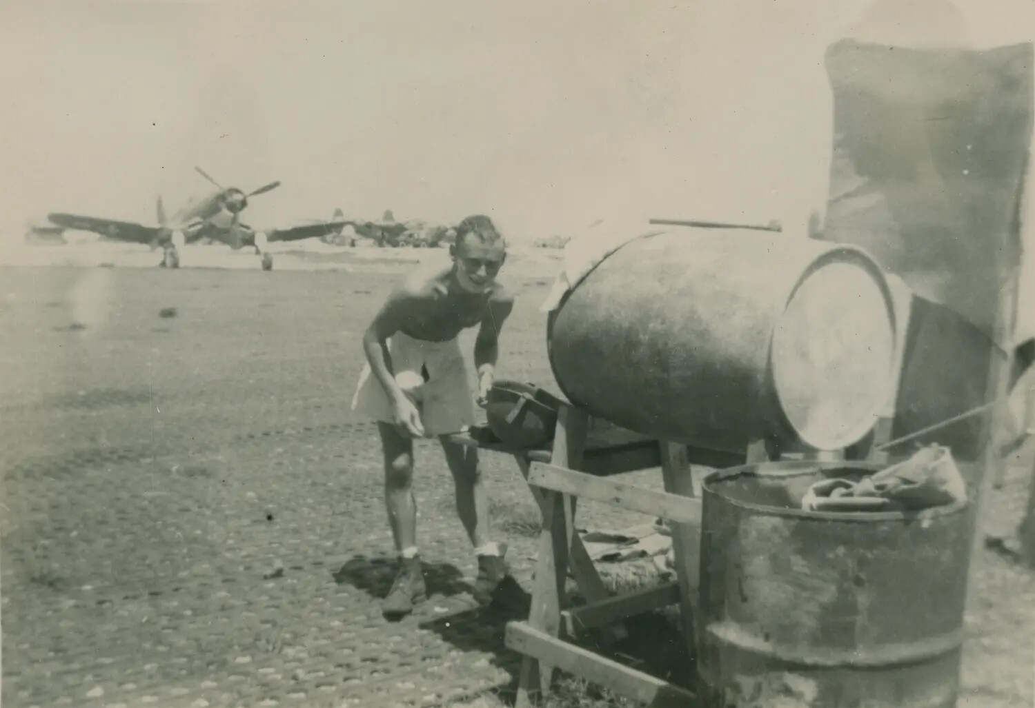 Airman Washing Up at Improvised Drum Stand, Forward Airfield