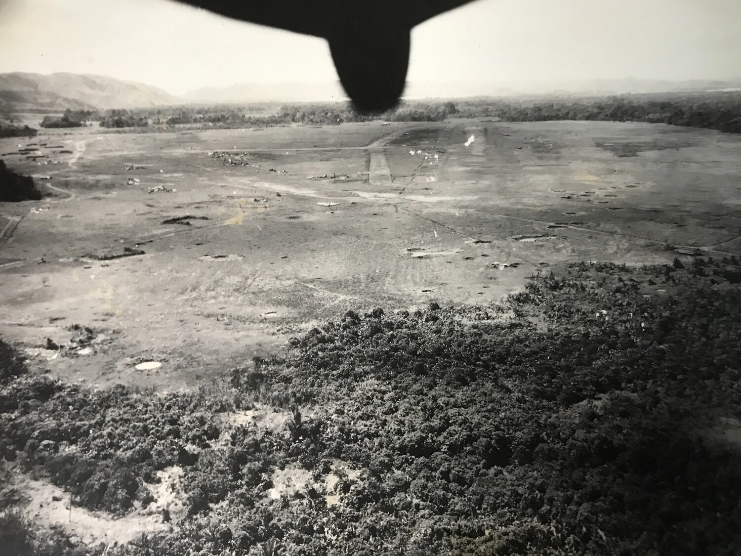 Oblique Low-Altitude View of Airfield Target from Attacking Aircraft, Propeller Visible