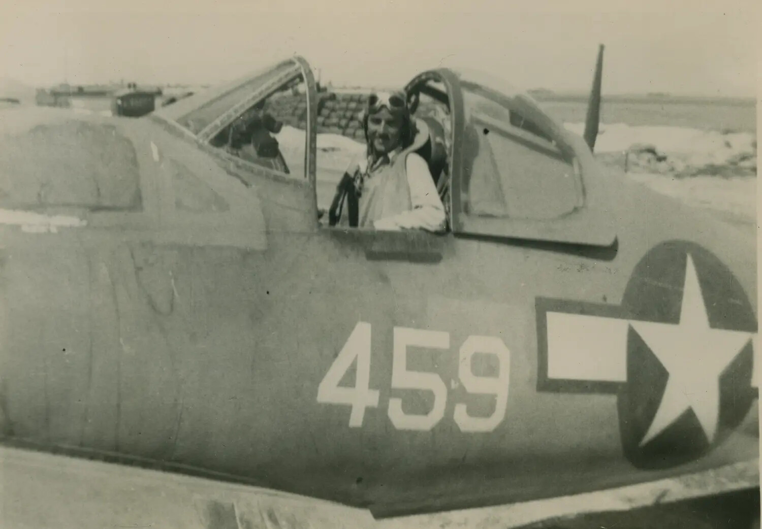 Pilot in Cockpit of Single-Engine Aircraft No. 459, Snow-Covered Airfield, WWII/Post-War Era