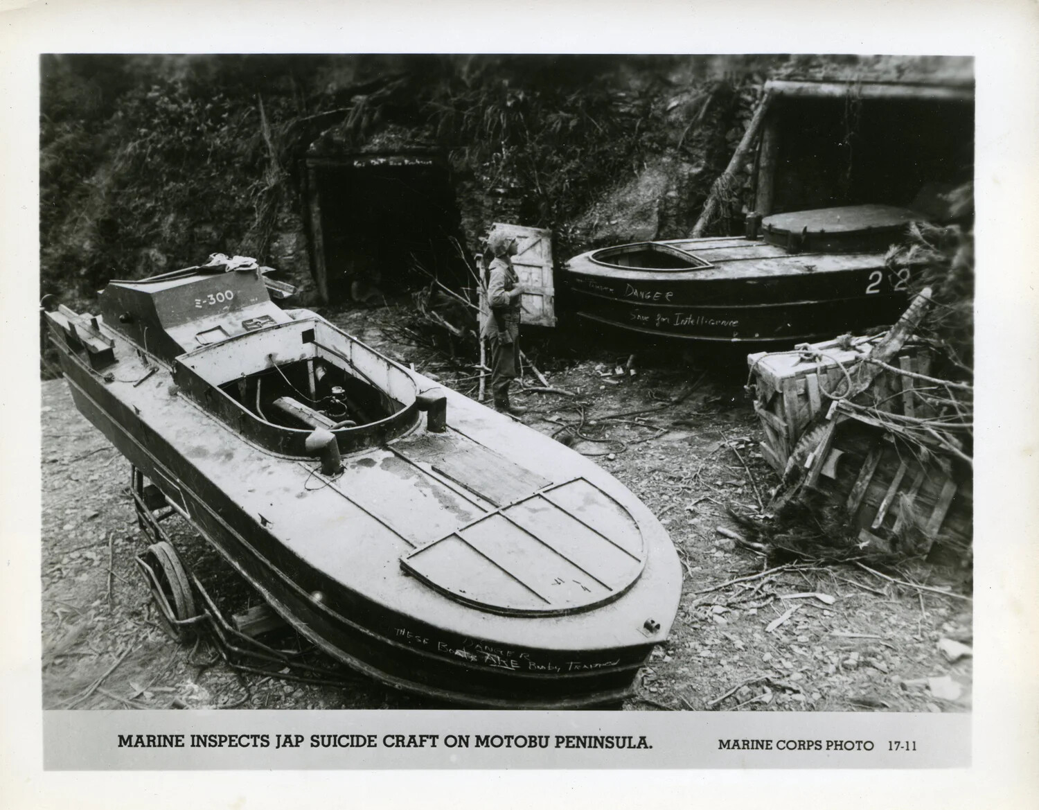 Marine Inspects Japanese Suicide Craft on Motobu Peninsula, Okinawa