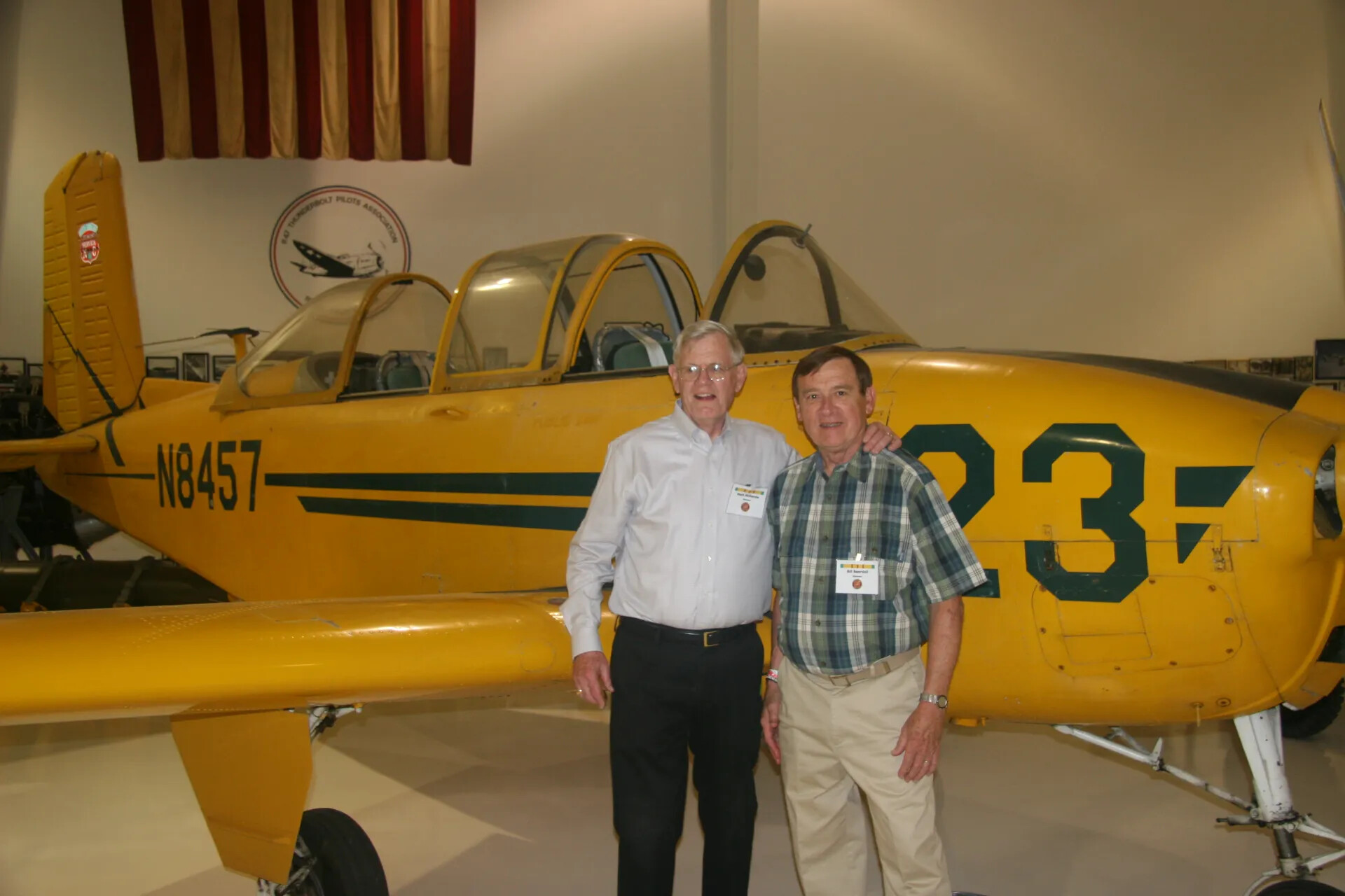 Two Veterans Posing Together with Vintage Training Aircraft at Aviation Museum, 2016 (Alternate View)