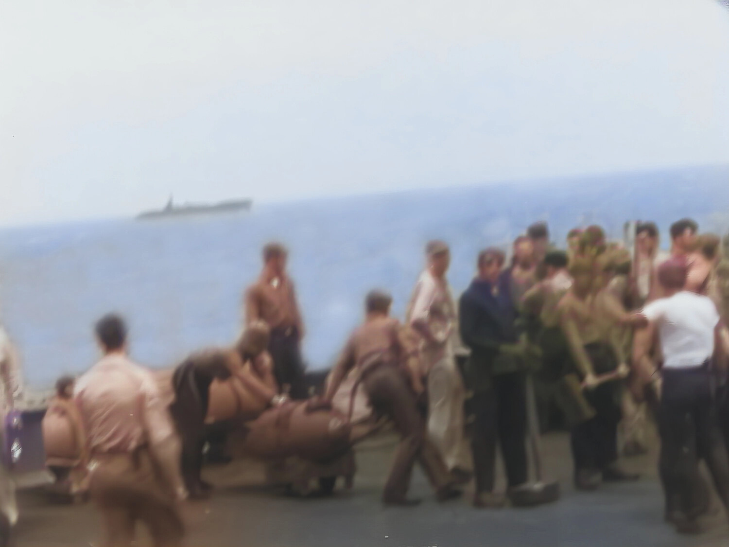 Upscaled/Colorized Still: Servicemen Carrying a Stretcher on Ship's Deck, Vessel Visible on Horizon -- Francis R. Ferry Yamato Collection