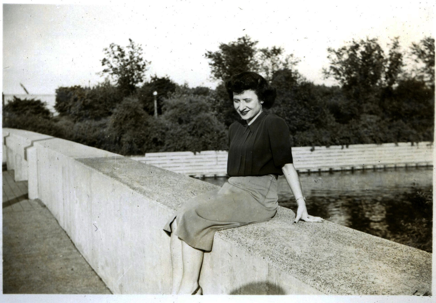 Portrait of a Young Woman Seated on a Reservoir Wall, Circa Late 1940s-Early 1950s