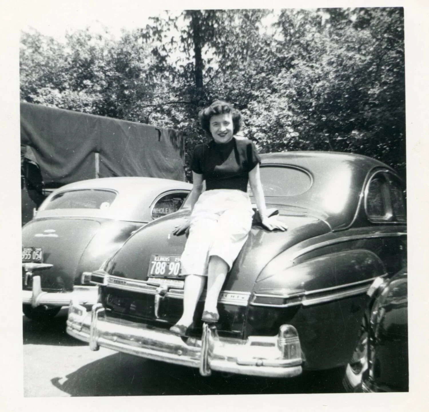 Woman Seated on Automobile, Personal Snapshot — Lt. Bancroft Korean War Album
