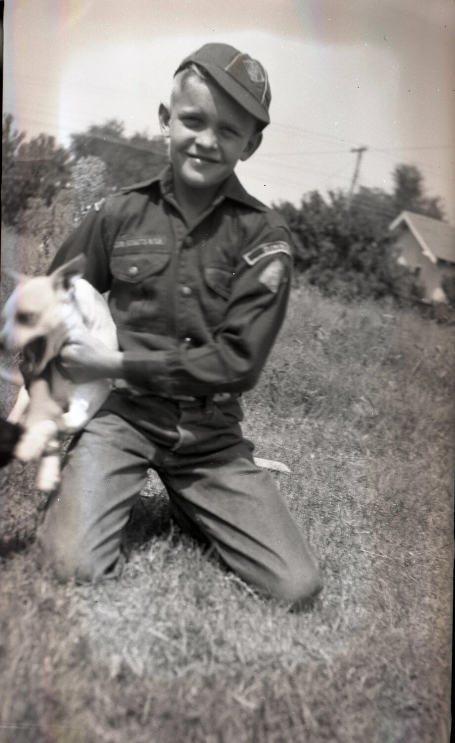 Boy in Scout Uniform Holding a Puppy, Kelley Family Album (Personal Snapshot)