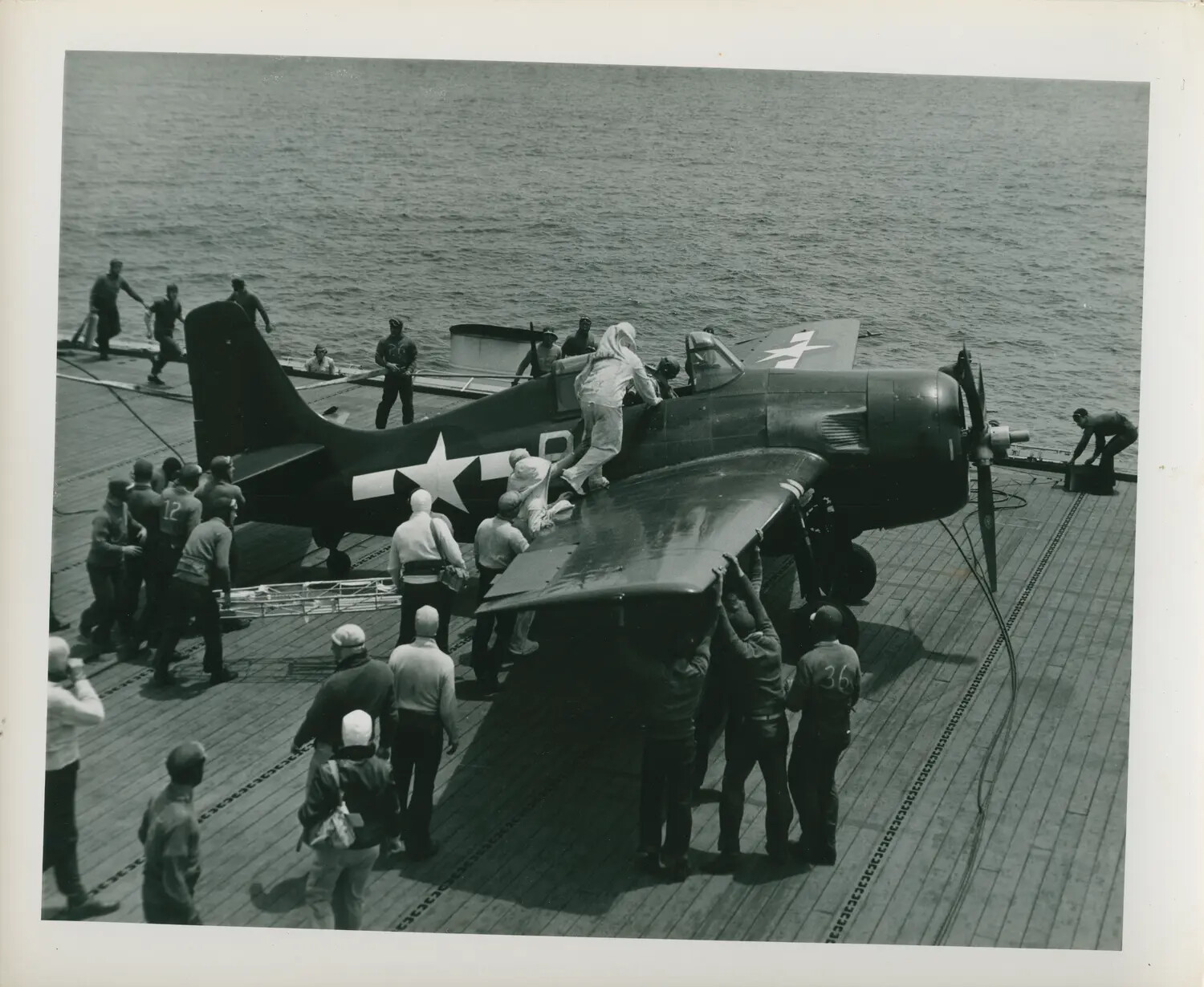 Flight Deck Crew Spotting a Carrier Fighter Aircraft Aboard USS Petrof Bay (CVE-80), WWII