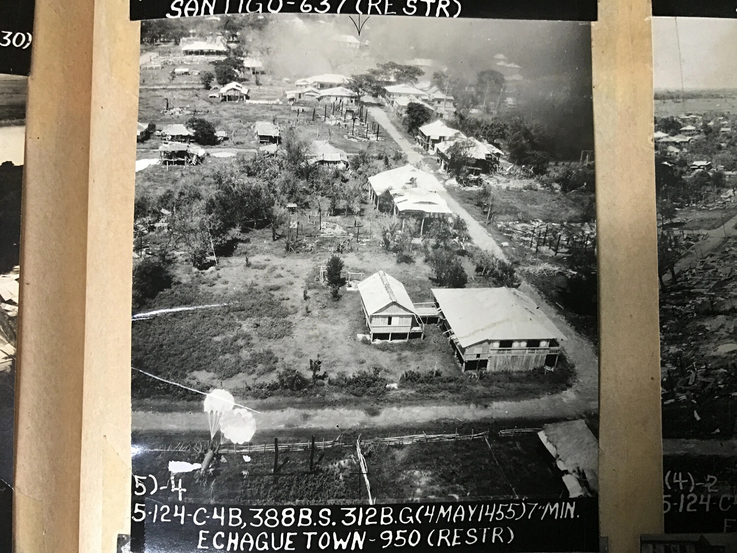 312th Bomb Group Strike Photograph with Parafrag Bomb in Descent — Echague, Isabela, Luzon, 4 May 1945