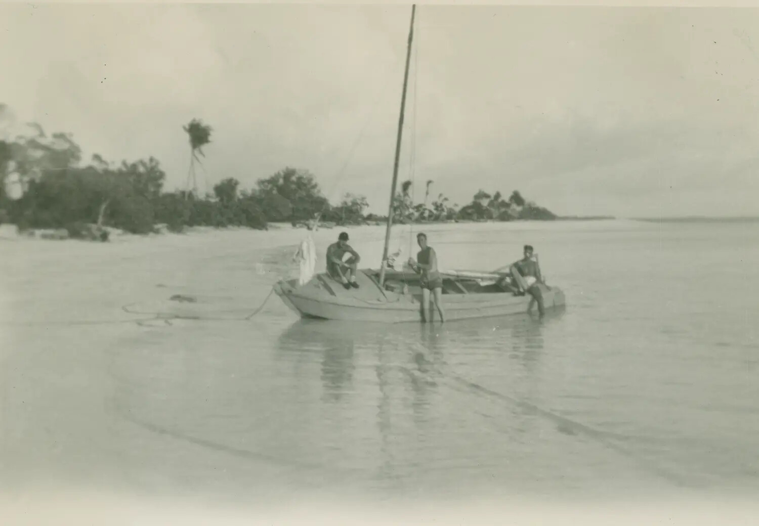 Servicemen with Small Sailboat in Pacific Island Lagoon, WWII Era