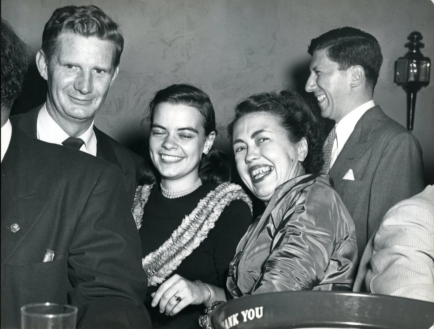 Laughing Group with Woman Wearing Shell Lei at Convention Reception, Late 1940s