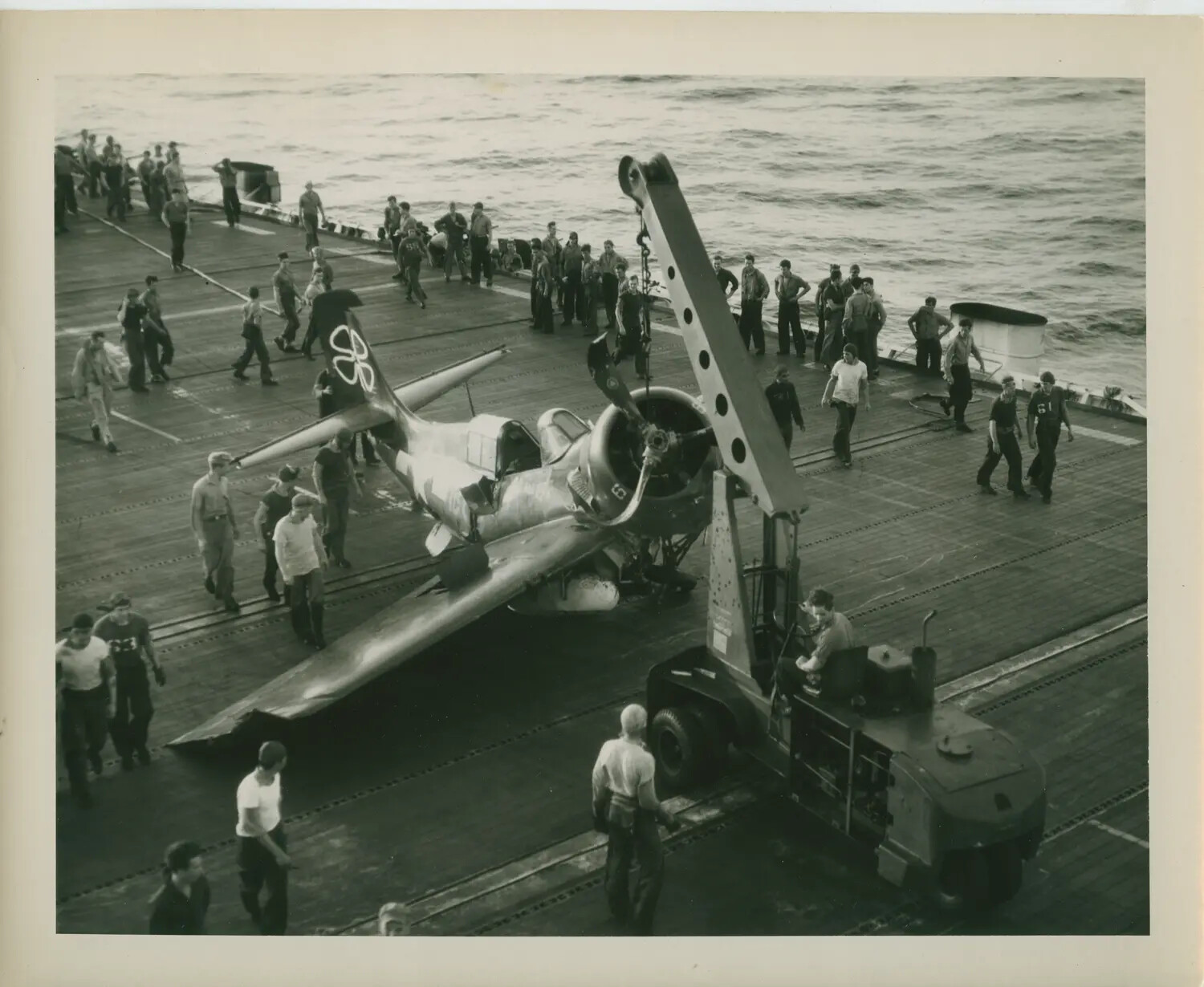 Wrecked FM-2 Wildcat Fighter Being Recovered by Flight Deck Crash Crane, USS Petrof Bay (CVE-80), WWII