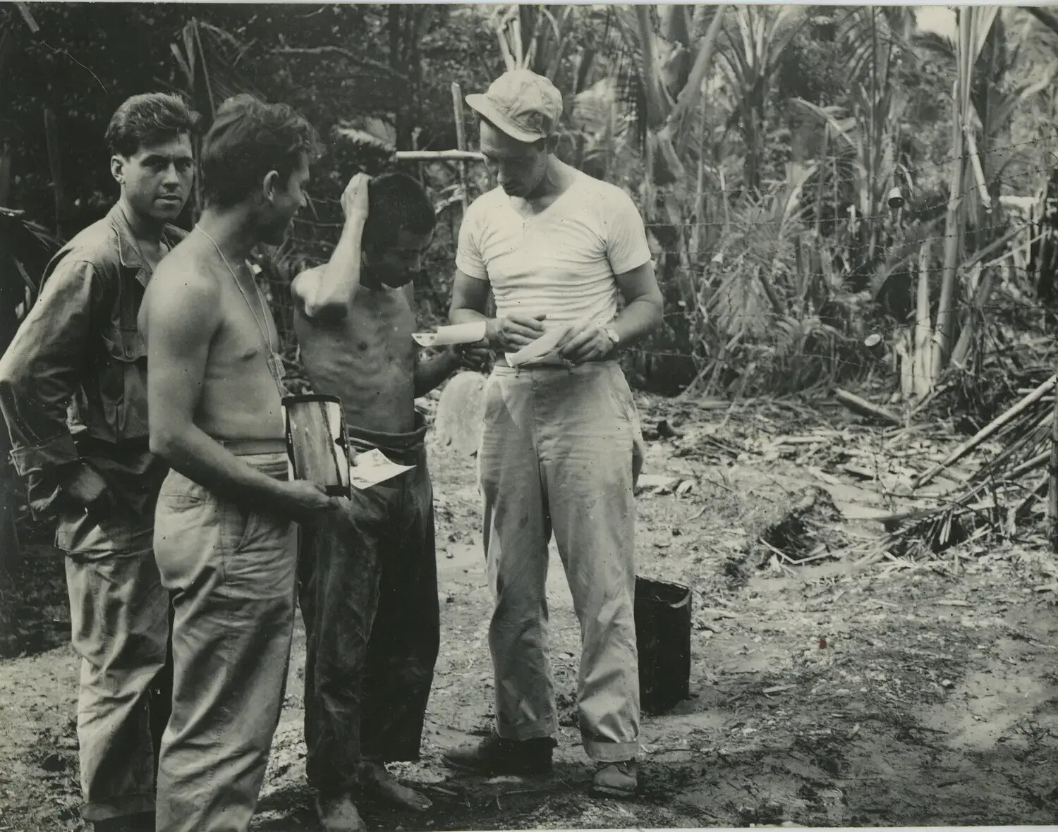 Servicemen Reviewing Identification Papers in Jungle Camp, 312th Bomb Group Area of Operations