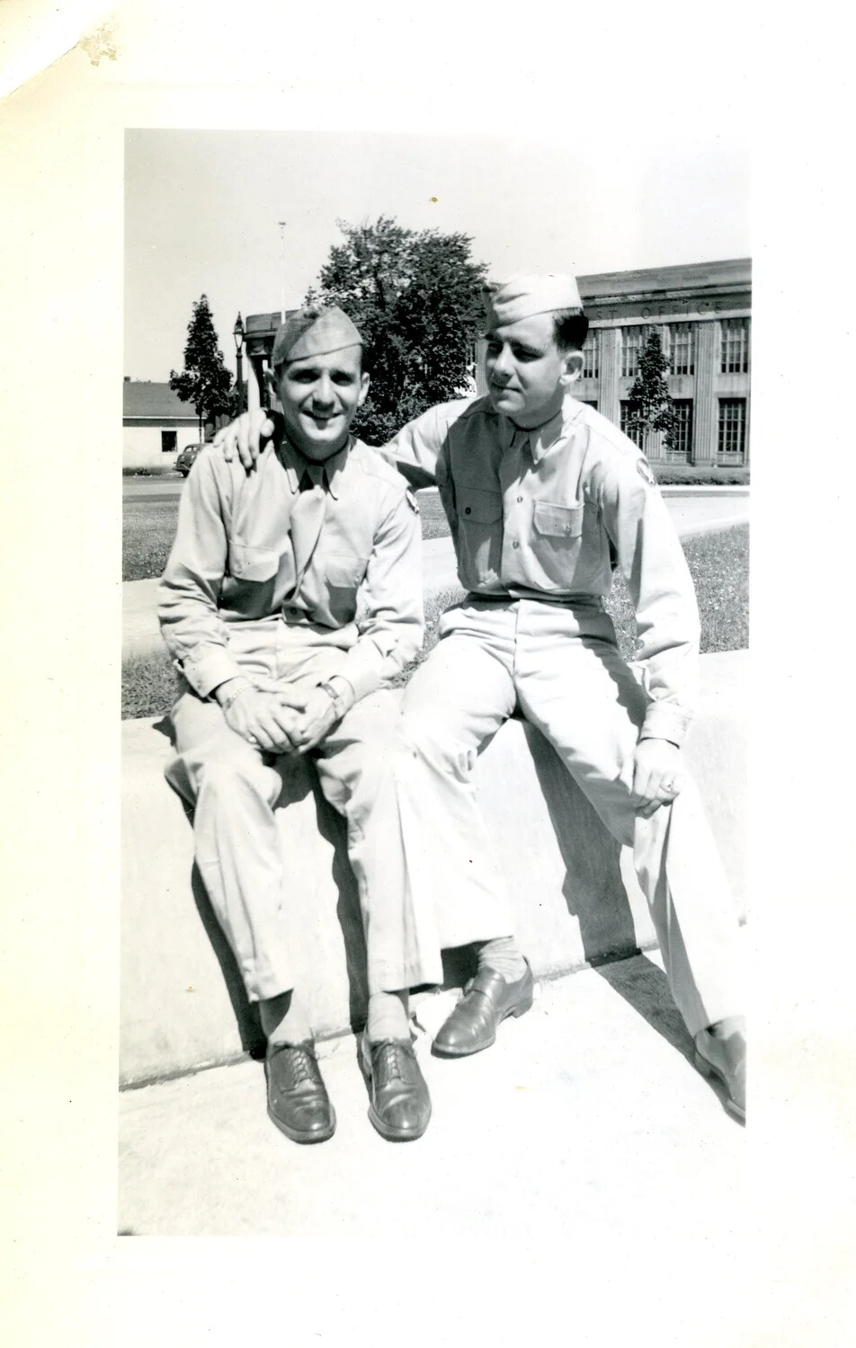 Two Servicemen Seated Outside Post Office Building, WWII-era Personal Photograph