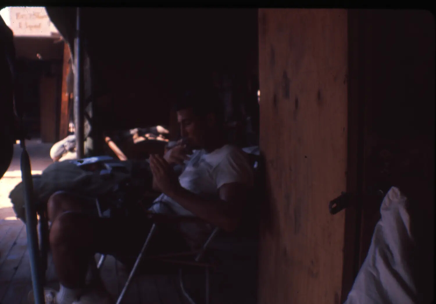 Serviceman Seated in Covered Area, Vietnam War Era (Cam Ranh Bay Collection)