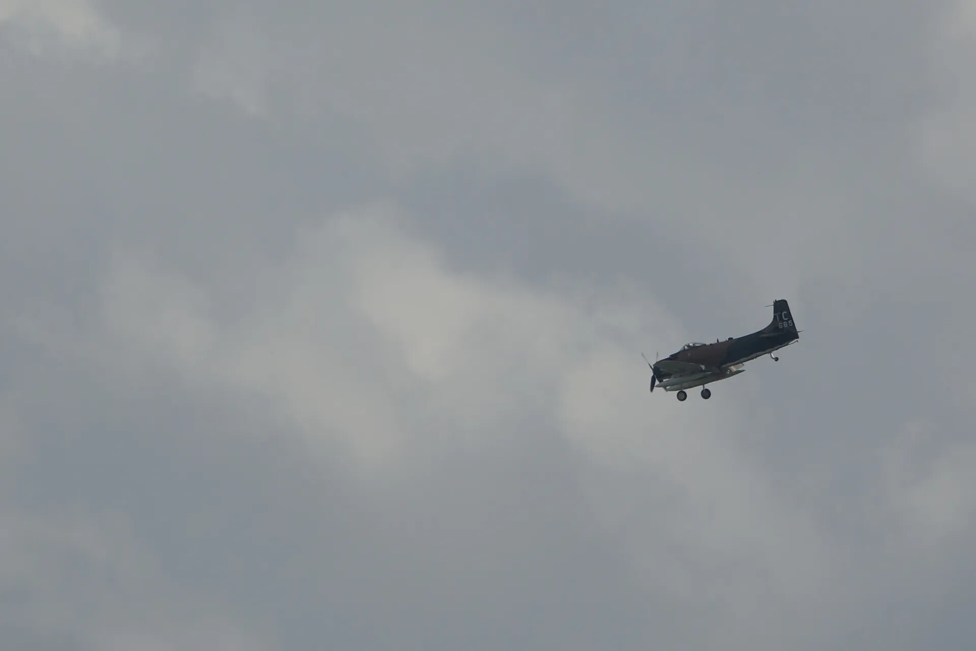 Douglas A-1 Skyraider 'TC 665' in Flight, Gear Down, Overcast Sky