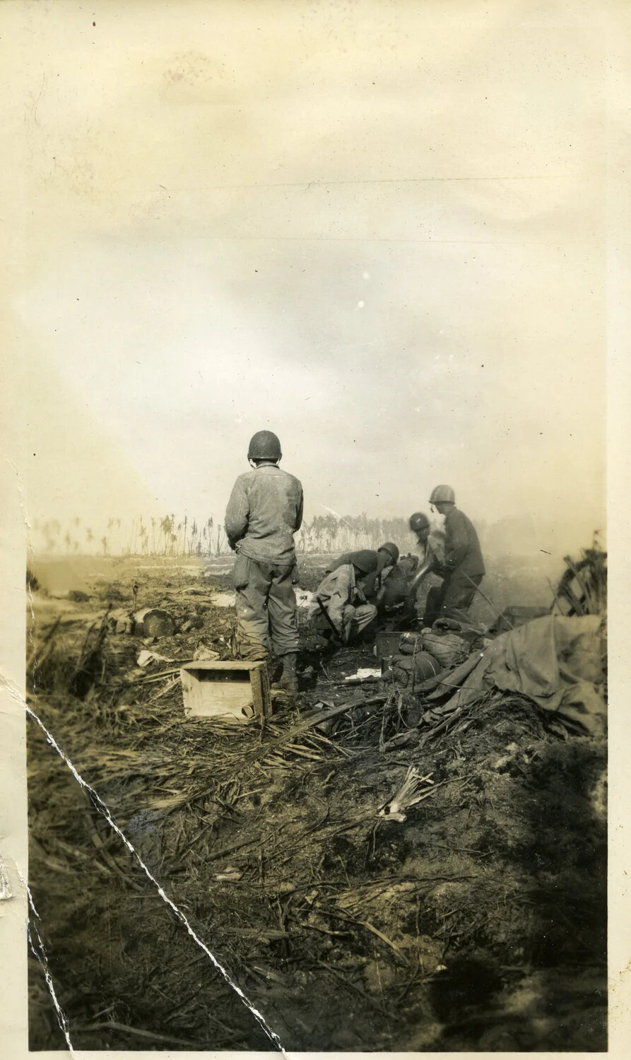 Servicemen at Equipment Position in Smoke-Hazed Battle Landscape, Kwajalein