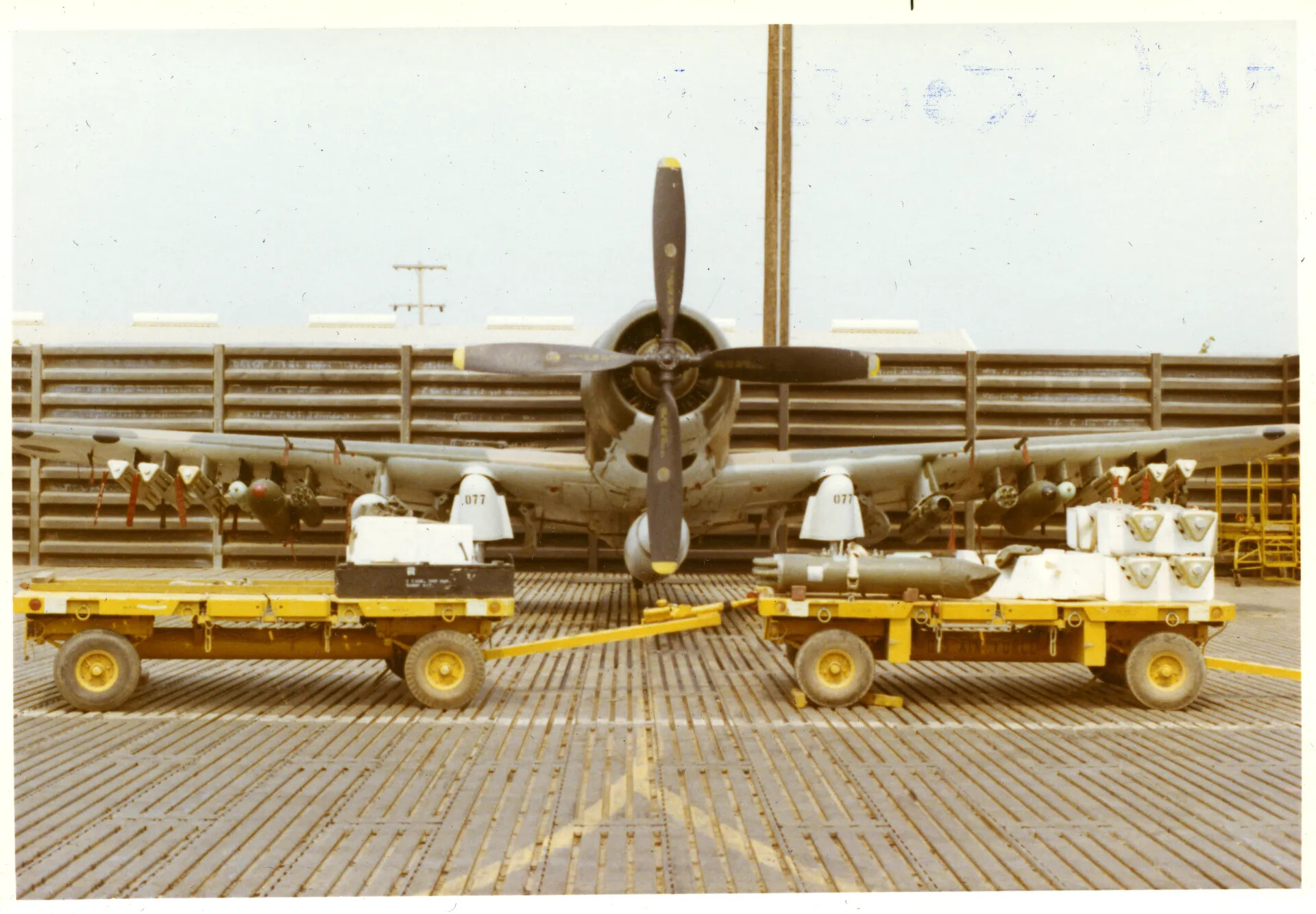 A-1 Skyraider '077' on Flight Line with Ordnance Carts, NKP Air Base, Vietnam War Era