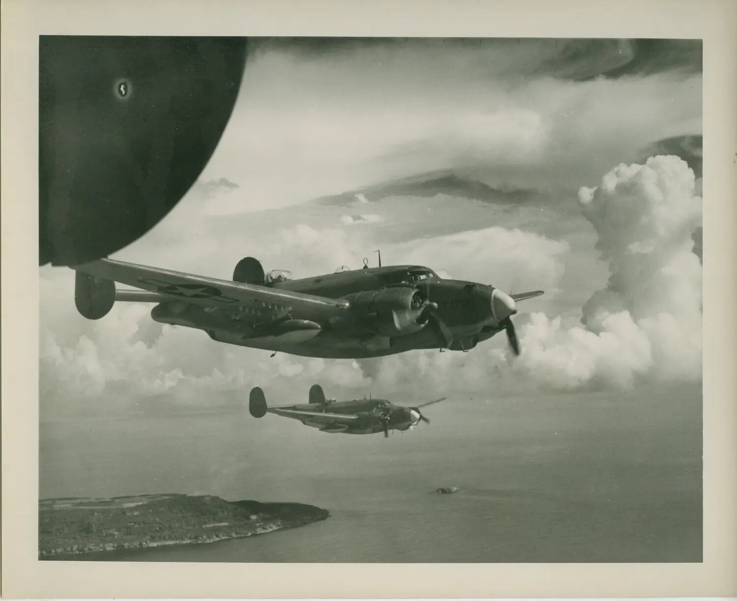 Twin-Engine U.S. Navy Patrol Bombers in Formation Over Tropical Coastline, WWII