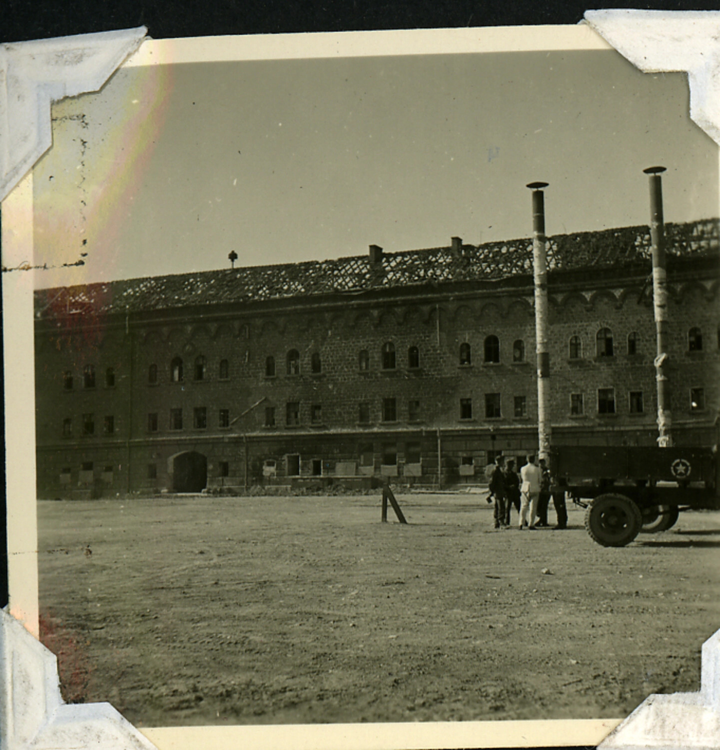 U.S. Army Personnel and Cargo Truck Before Damaged Masonry Barracks Building, WWII-Era Album