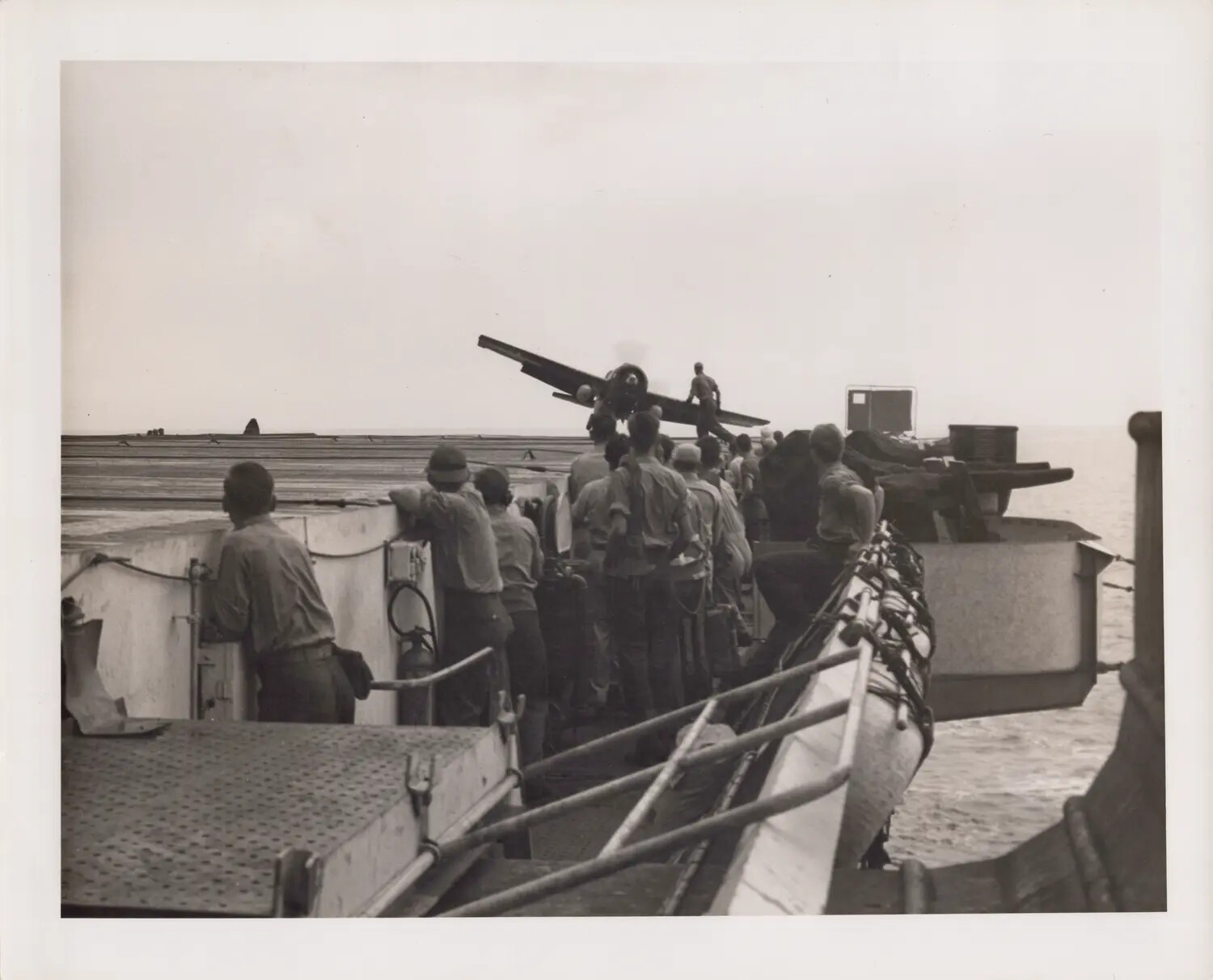 Sailors Watching an Aircraft Jettisoned Over the Side of an Escort Carrier Flight Deck, WWII