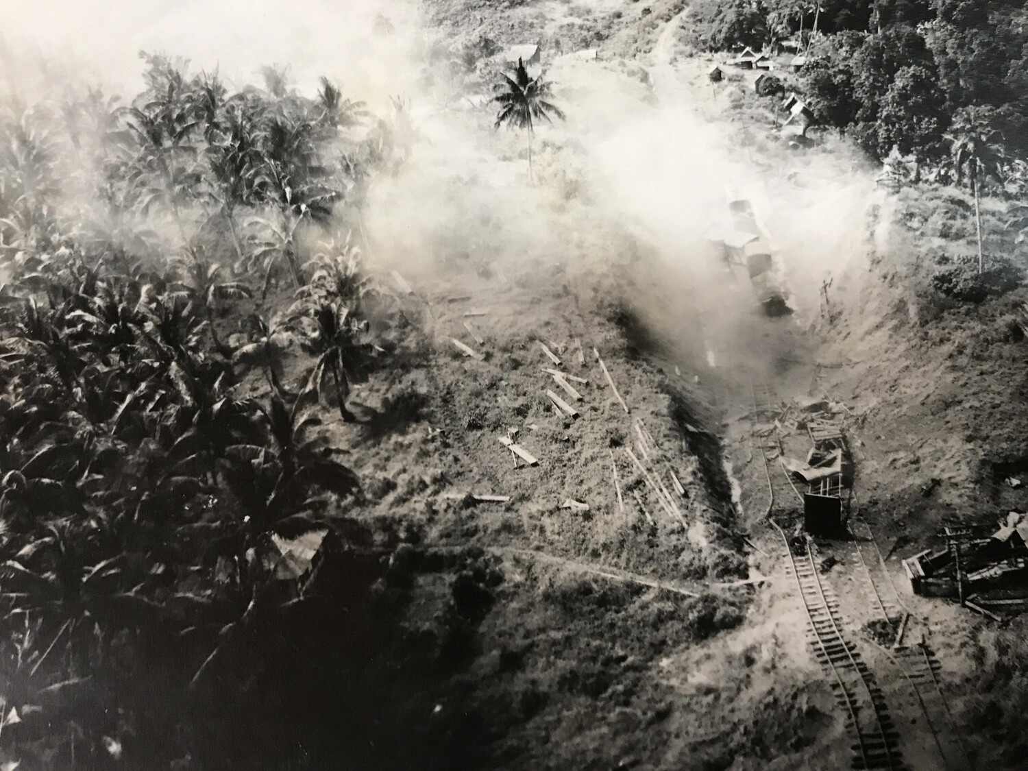 Aerial Strike Photograph of Bombing/Strafing Damage Along a Coastal Rail Line, Pacific Theater