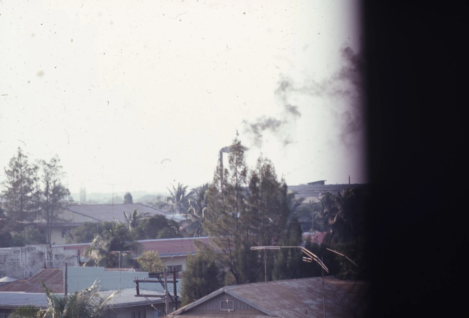 Vietnamese Town Rooftops with Rising Smoke, Vietnam War Era (USS Ticonderoga Collection)