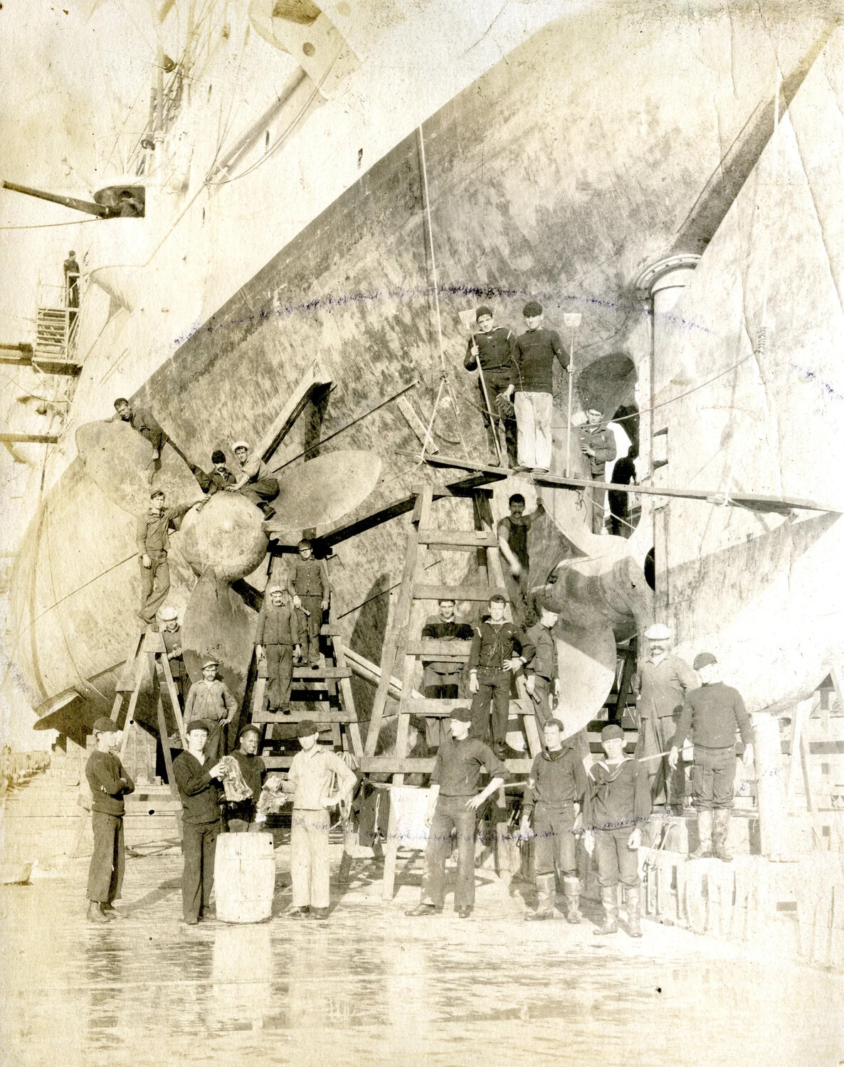 USS Columbia in Dry Dock: Crew Posed on the Twin Screw Propellers and Rudder
