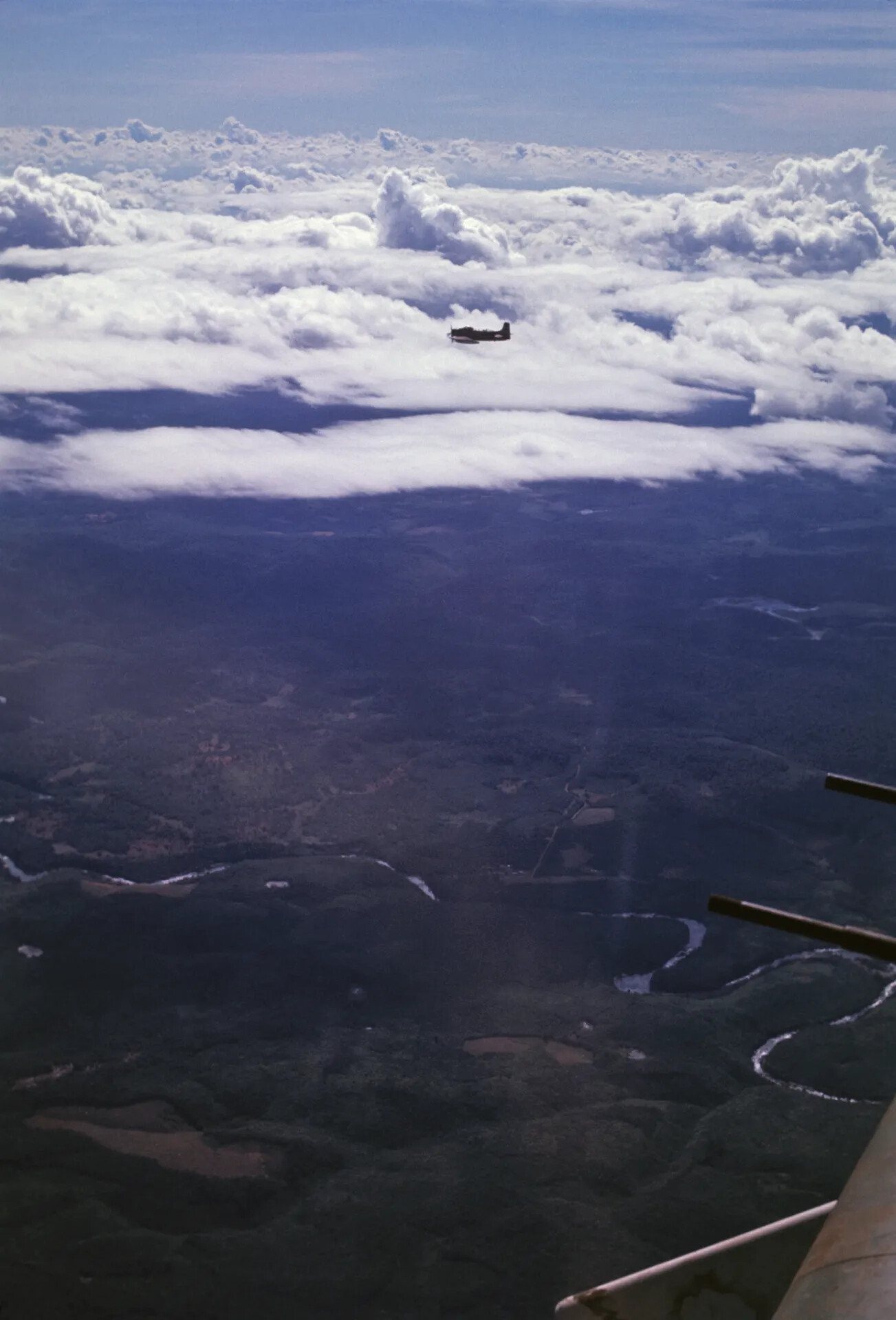 Douglas A-1 Skyraider Silhouetted Against Cumulus Clouds, Southeast Asia, circa 1970