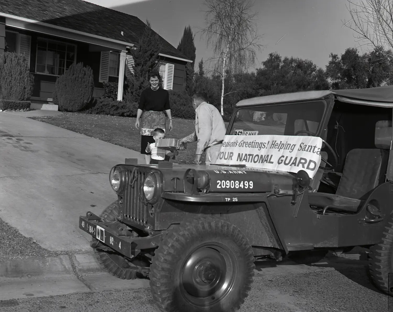 National Guard Christmas Toy Delivery to a Family in a Suburban Driveway