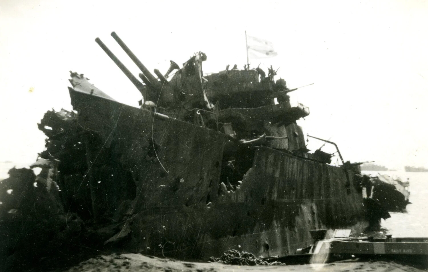 Wrecked Japanese Vessel with Gun Mount and Flag, Iwo Jima, 1945