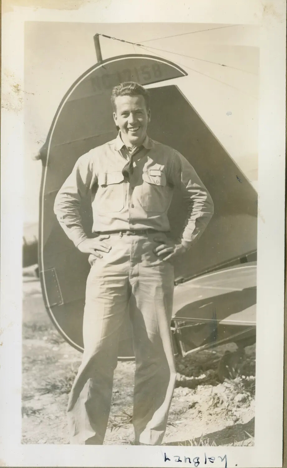 Aviation Cadet 'Langley' at the Tail of a Civil-Registered Training Airplane (NC12158)