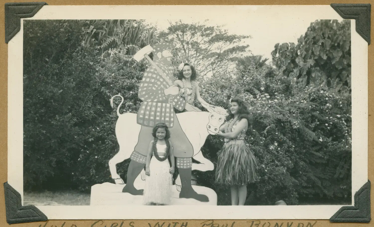 Snapshot: 'Hula Girls with Paul Bunyan' -- Novelty Photo Display, Hawaii, WWII Era