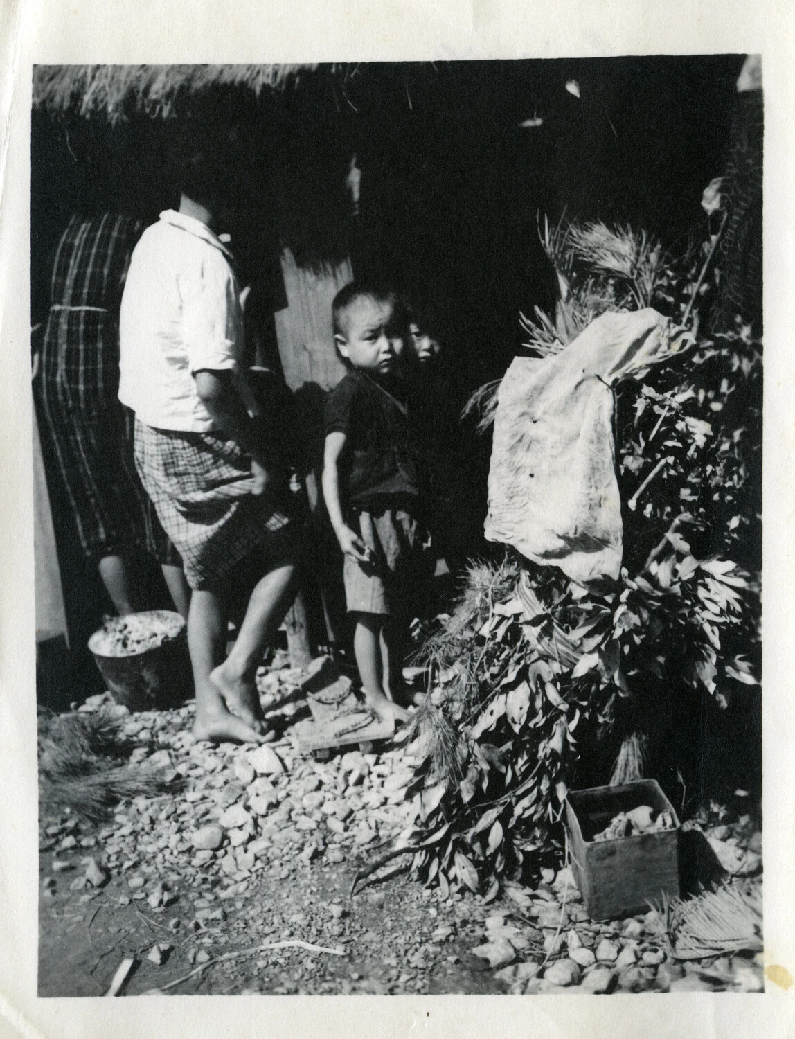 Okinawan Villagers Outside a Thatched Dwelling, Okinawa, WWII Era