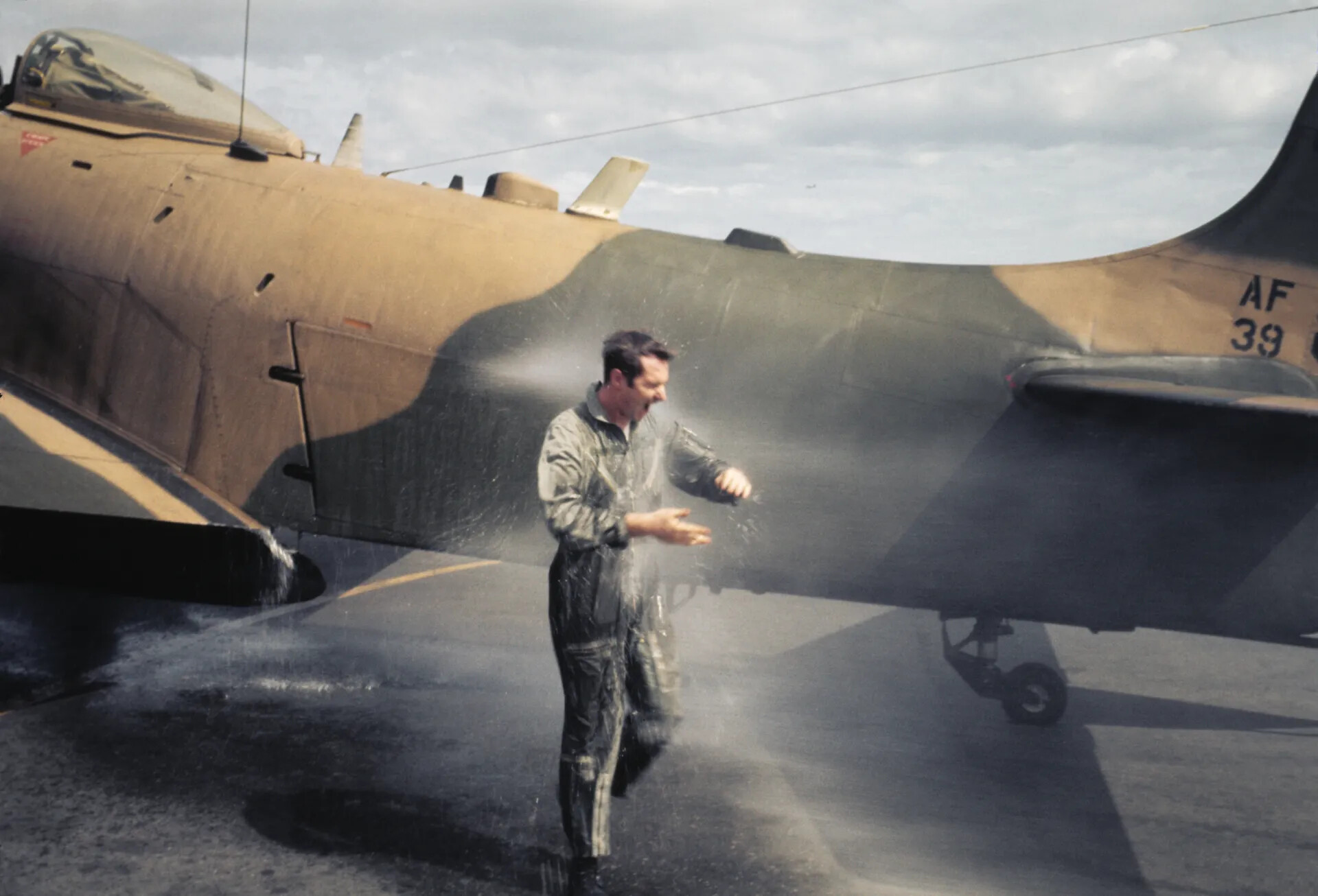 Pilot Doused in Water During 'Fini Flight' Celebration Beside A-1 Skyraider (AF 39)