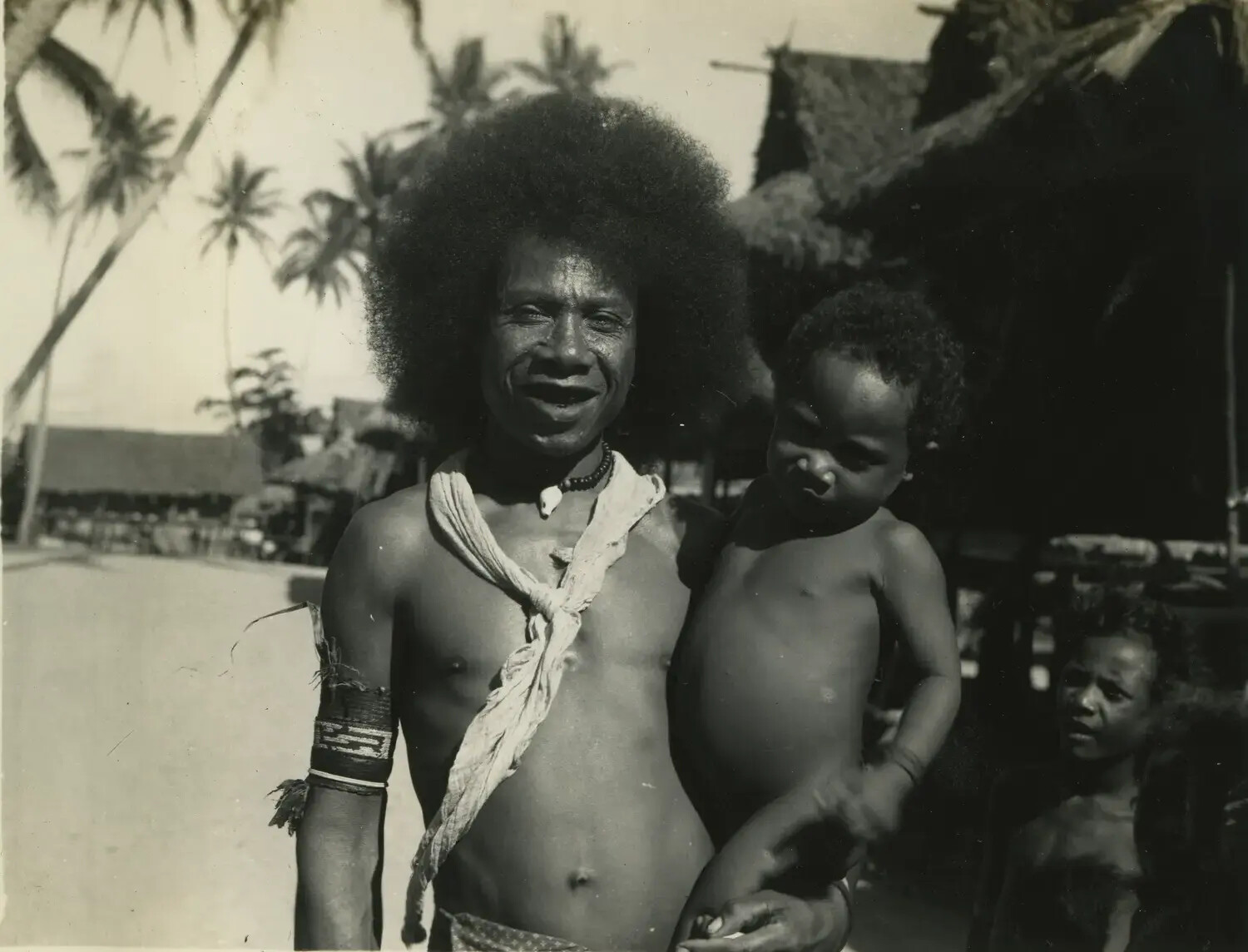 Portrait of a Melanesian Man and Child in a Village, Pacific Theater