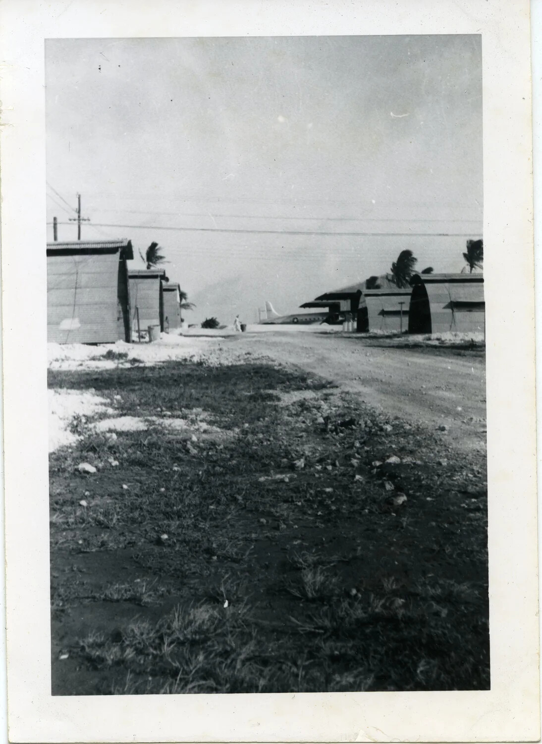 Quonset Hut Row with Transport Aircraft in Background, VR-6 Base, Agana, Guam