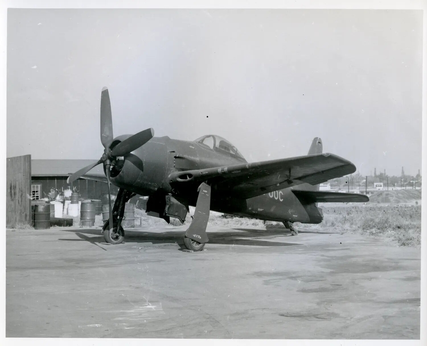 Single-Engine U.S. Navy Radial Fighter Aircraft on Ramp, Possible Grumman F8F Bearcat