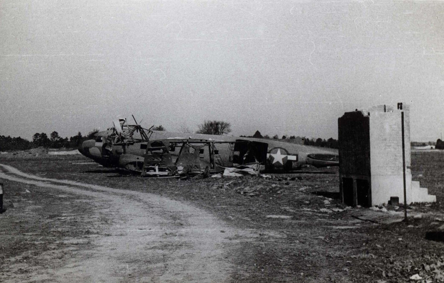 Wrecked Twin-Engine Aircraft Fuselage Near Roadside Structure, European Theater, WWII