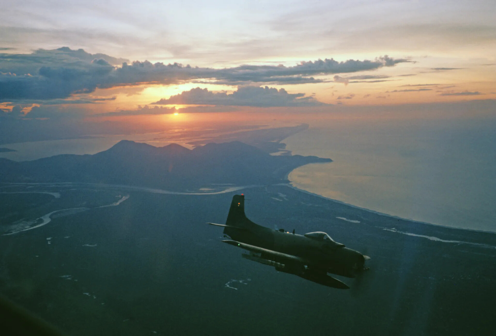 A-1 Skyraider in Silhouette at Sunset over Vietnamese Coastline