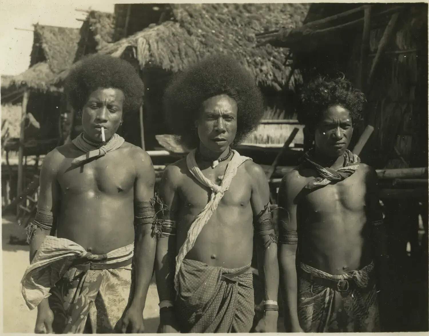 Portrait of Three Melanesian Men in a Village, Pacific Theater