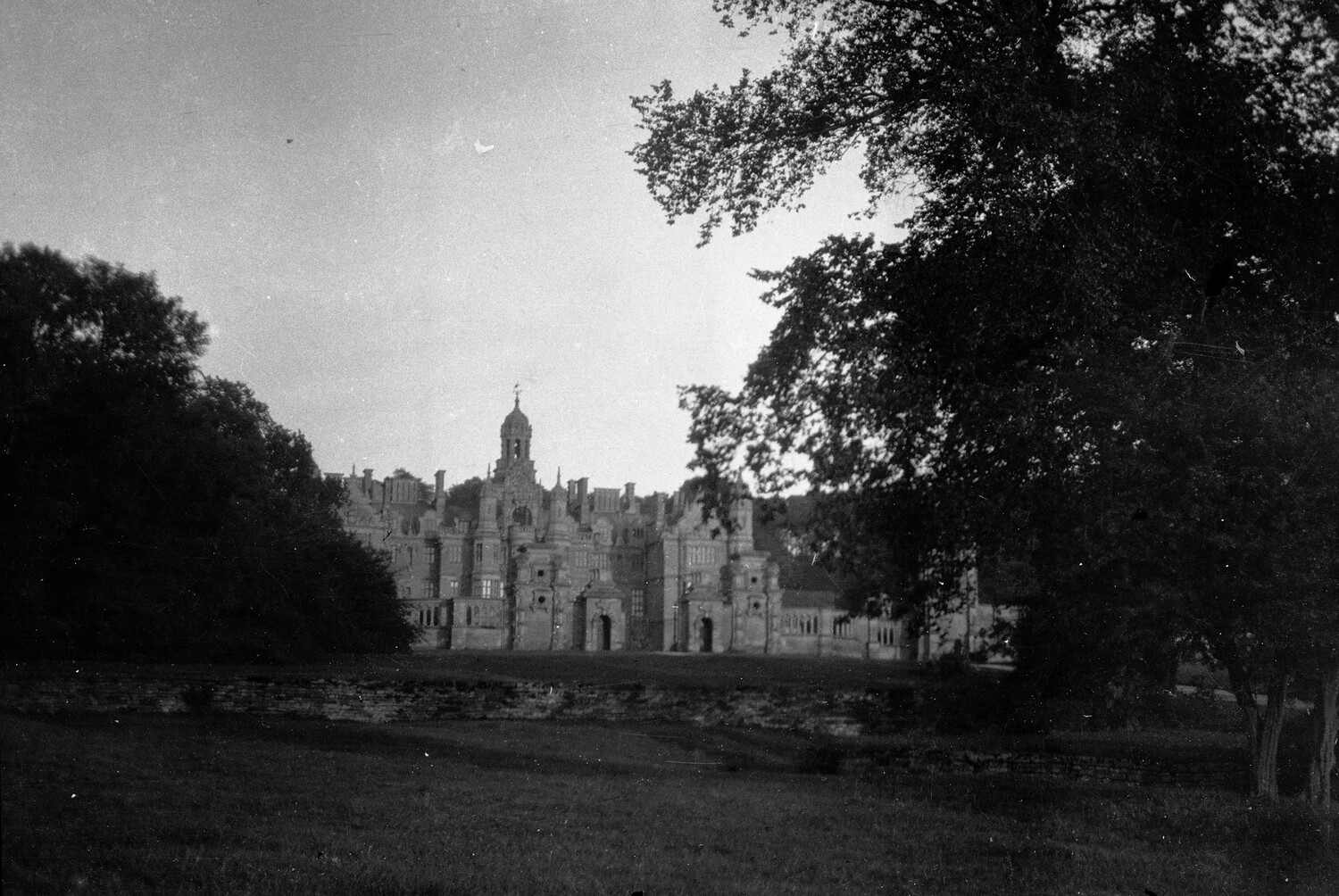 Harlaxton Manor, Grantham, Lincolnshire, England — Distant View Through Trees