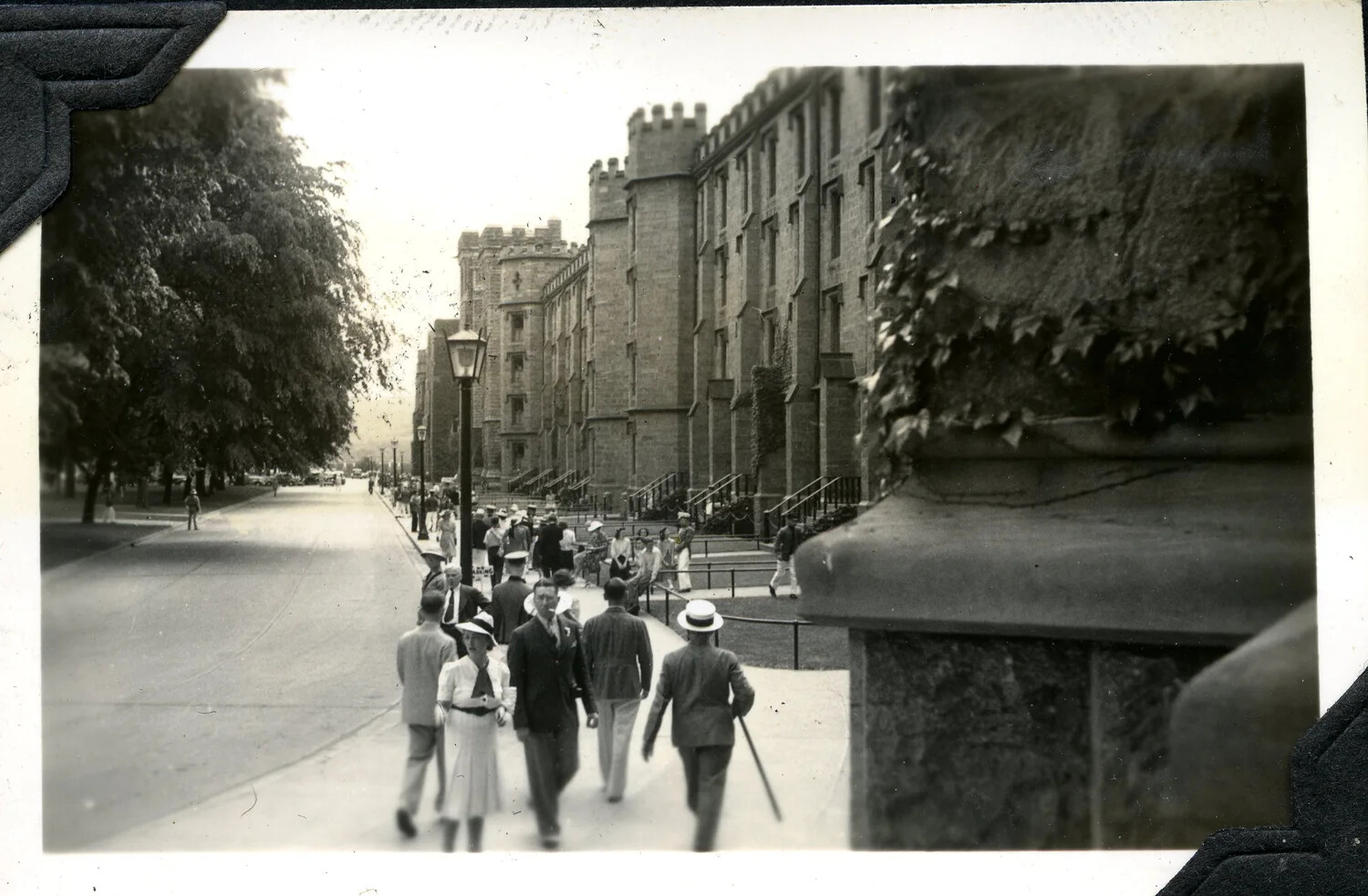 Pedestrians on a Tree-Lined Street Before Collegiate Gothic Buildings, c. 1920s-1930s